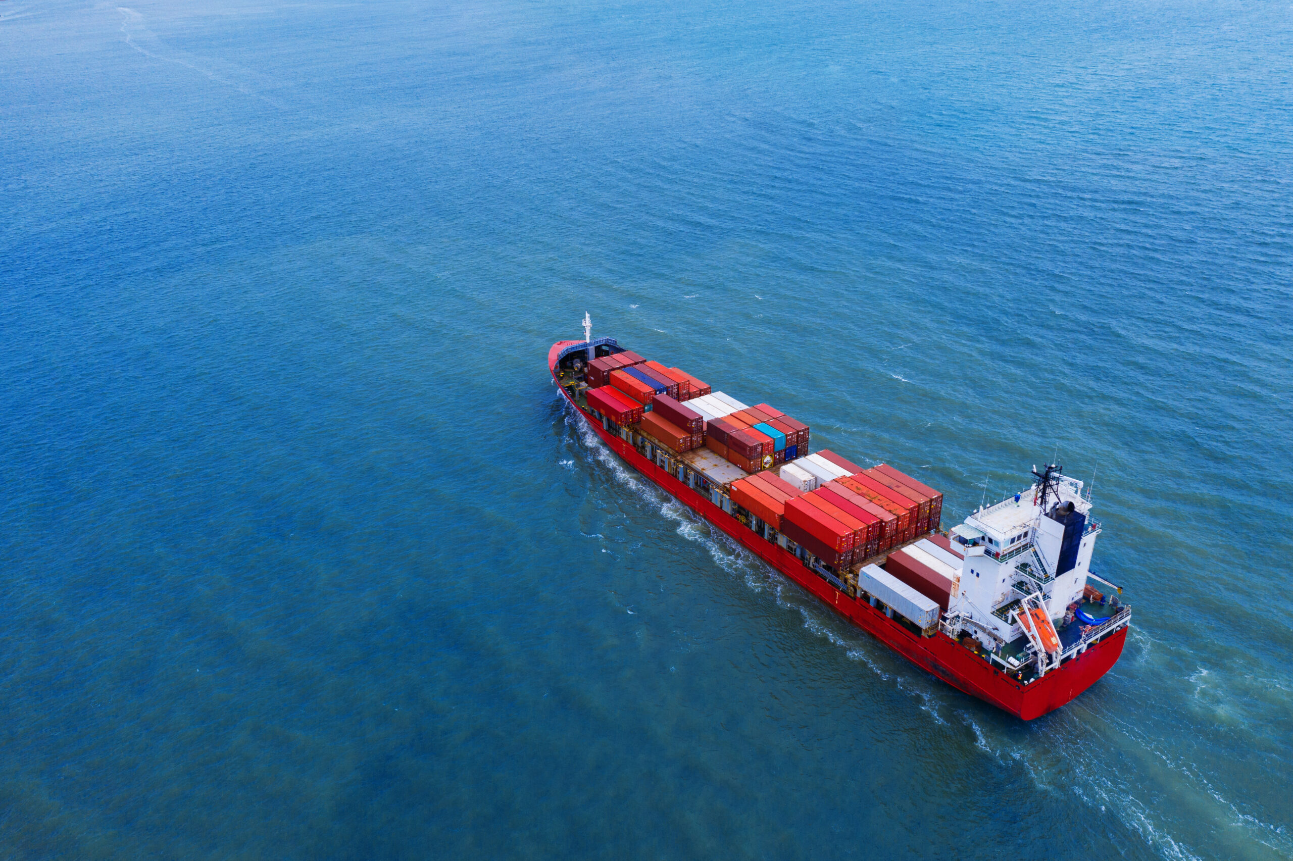 Aerial view of container cargo ship in sea.