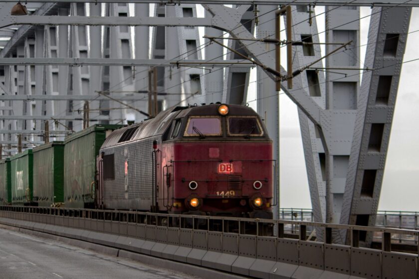 Old red train with green wagons during daytime